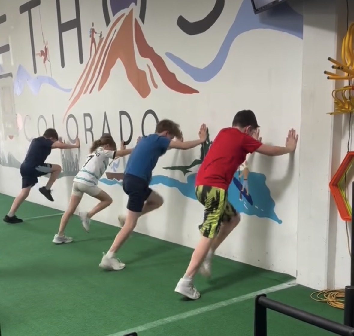 Young athletes doing wall sprint drills at ETHOS